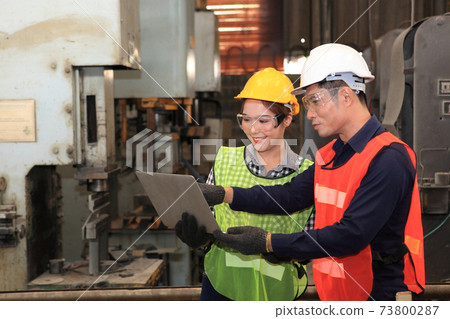 Male and Female Industrial Engineers with  machine. Assist production engineer in industry. He checking or push metalwork control in industrial In a plastic factory for car. Concept Successful of 73800287