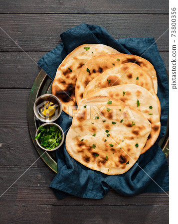 naan flatbreads on dark wood, copy space, vertical naan flatbreads on dark wood, copy space, vertical 73800356
