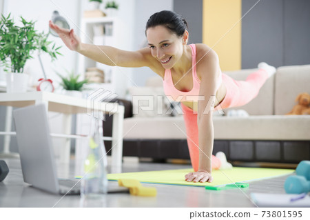 Woman doing balance exercises at home closeup Woman doing balance exercises at home closeup 73801595