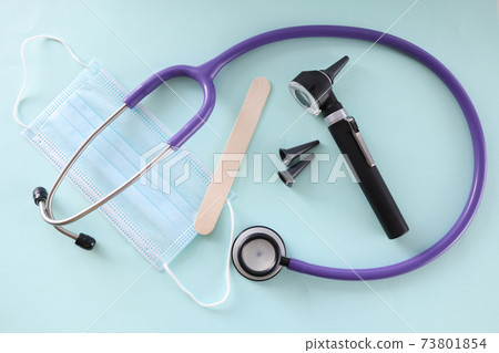 On table is protective otoscope mask and throat shelf 73801854
