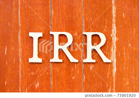 Alphabet letter in word IRR (Abbreviation of internal rate of return) on old red color wood plate background 73801920