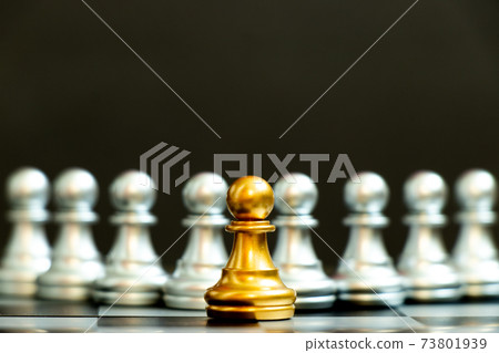 Gold pawn piece stand in fron of silver pawn team on black background (Concept for leader, unique or outstanding) Gold pawn piece stand in fron of silver pawn team on black background (Concept for leader, unique or outstanding) 73801939