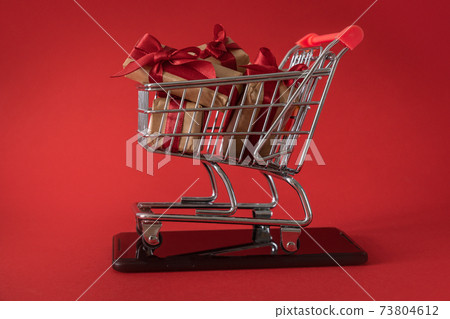 Online shopping for Valentine's day concept - presents in shopping cart 73804612
