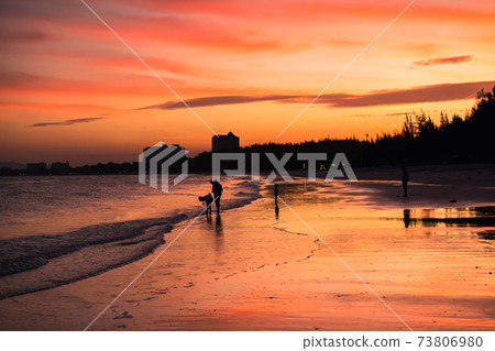 Happy silhouette family enjoy beach at dusk 73806980