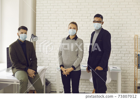 People wear face masks in office, caring about health of customers and coworkers 73807012