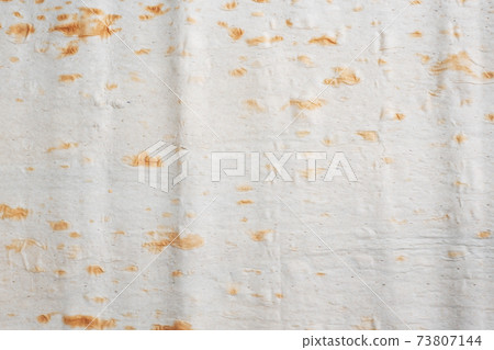 Close up Background Thin Armenian lavash. Texture of natural bread baking. Close up Background Thin Armenian lavash. Texture of natural bread baking. 73807144