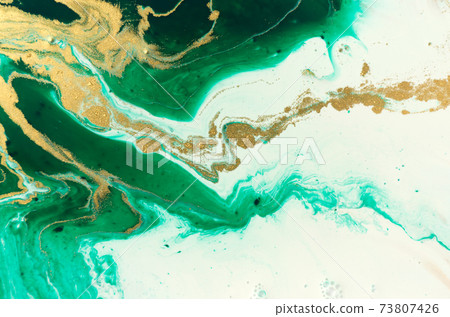 Green and gold marble abstract acrylic background. Marbling artwork texture. Agate ripple pattern. Gold powder. 73807426