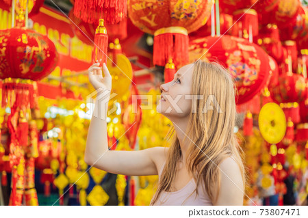 Beautiful Caucasian tourist woman in Tet holidays. Vietnam Chinese Lunar New Year in springtime 73807471