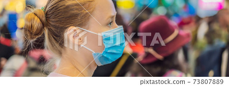 Woman traveler with medical face mask to protection the coronavirus in airport BANNER, LONG FORMAT 73807889