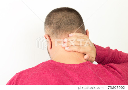 Man suffering from pain in neck or cervical spine, back view 73807902