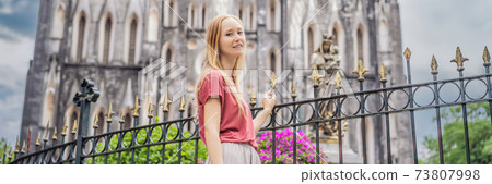 BANNER, LONG FORMAT Young woman tourist on background of St Joseph's Cathedral in Hanoi. Vietnam reopens after coronavirus quarantine COVID 19 73807998