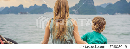 BANNER, LONG FORMAT Mom and son travelers is traveling by boat in Halong Bay. Vietnam. Travel to Asia, happiness emotion, summer holiday concept. Traveling with children concept. After COVID 19 BANNER, LONG FORMAT Mom and son travelers is traveling by boat in Halong Bay. Vietnam. Travel to Asia, happiness emotion, summer holiday concept. Traveling with children concept. After COVID 19 73808049