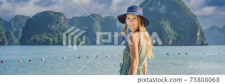 BANNER, LONG FORMAT Attractive woman in a dress is traveling in Halong Bay. Vietnam. Travel to Asia, happiness emotion, summer holiday concept. Picturesque sea landscape. Ha Long Bay, Vietnam BANNER, LONG FORMAT Attractive woman in a dress is traveling in Halong Bay. Vietnam. Travel to Asia, happiness emotion, summer holiday concept. Picturesque sea landscape. Ha Long Bay, Vietnam 73808068