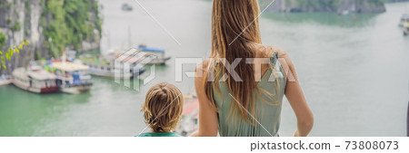 BANNER, LONG FORMAT Mom and son travelers in Halong Bay. Vietnam. Travel to Asia, happiness emotion, summer holiday concept. Picturesque sea landscape. Ha Long Bay, Vietnam. After coronavirus COVID 19 BANNER, LONG FORMAT Mom and son travelers in Halong Bay. Vietnam. Travel to Asia, happiness emotion, summer holiday concept. Picturesque sea landscape. Ha Long Bay, Vietnam. After coronavirus COVID 19 73808073