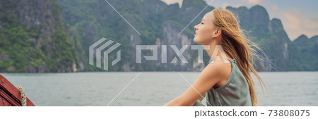 BANNER, LONG FORMAT Attractive woman in a dress is traveling by boat in Halong Bay. Vietnam. Travel to Asia, happiness emotion, summer holiday concept. Picturesque sea landscape. Ha Long Bay, Vietnam BANNER, LONG FORMAT Attractive woman in a dress is traveling by boat in Halong Bay. Vietnam. Travel to Asia, happiness emotion, summer holiday concept. Picturesque sea landscape. Ha Long Bay, Vietnam 73808075