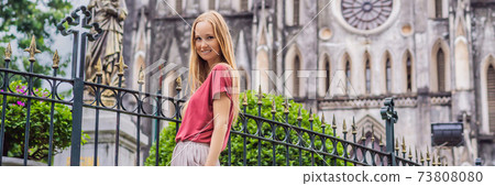BANNER, LONG FORMAT Young woman tourist on background of St Joseph's Cathedral in Hanoi. Vietnam reopens after coronavirus quarantine COVID 19 BANNER, LONG FORMAT Young woman tourist on background of St Joseph's Cathedral in Hanoi. Vietnam reopens after coronavirus quarantine COVID 19 73808080