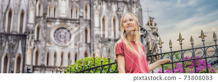 BANNER, LONG FORMAT Young woman tourist on background of St Joseph's Cathedral in Hanoi. Vietnam reopens after coronavirus quarantine COVID 19 BANNER, LONG FORMAT Young woman tourist on background of St Joseph's Cathedral in Hanoi. Vietnam reopens after coronavirus quarantine COVID 19 73808083