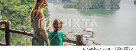 BANNER, LONG FORMAT Mom and son travelers in Halong Bay. Vietnam. Travel to Asia, happiness emotion, summer holiday concept. Picturesque sea landscape. Ha Long Bay, Vietnam. After coronavirus COVID 19 73808090
