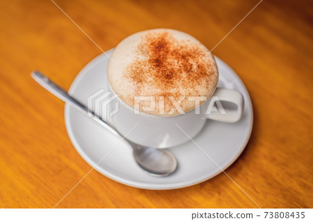 Top view a cup of Giang egg coffee on wood background. Vietnamese coffee in Ha Noi, Vietnam. Eggs are beaten with coffee, hot drink or with ice 73808435