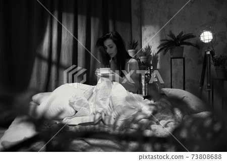 beautiful young woman drinking her coffee beautiful young woman drinking her coffee 73808688
