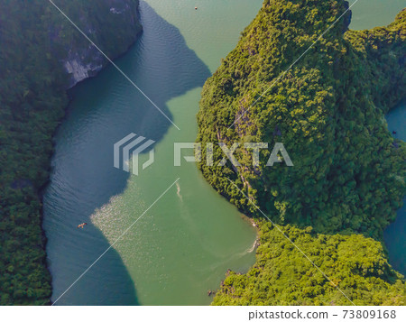 Aerial view panorama of floating fishing village and rock island, Halong Bay, Vietnam, Southeast Asia. UNESCO World Heritage Site. Junk boat cruise to Ha Long Bay. Popular landmark of Vietnam Aerial view panorama of floating fishing village and rock island, Halong Bay, Vietnam, Southeast Asia. UNESCO World Heritage Site. Junk boat cruise to Ha Long Bay. Popular landmark of Vietnam 73809168