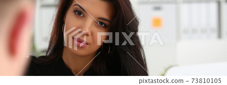 Pretty woman is talking with her colleague 73810105