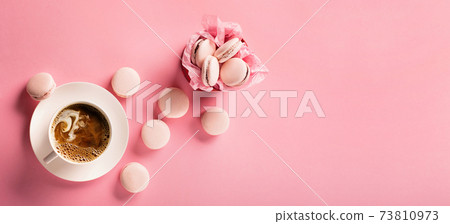 Morning cup of coffee, sweet cake macaroons, gift present box on pink background. 73810973