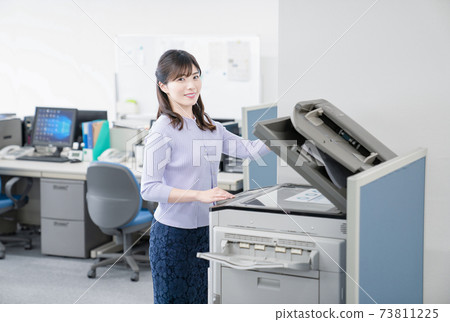Female employee making a copy in the office 73811225