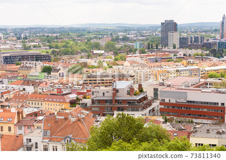 Brno. Czechia. May 2019. Panorama of Brno. The city rooftops and distant hills. 73811340