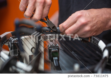 Stringing process of a new tennis racket, rocket string, sport concept 73811475