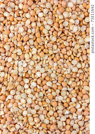 Pile of chipped peas close-up. Dry peas yellow, top view. Pile of chipped peas close-up. Dry peas yellow, top view. 73811692