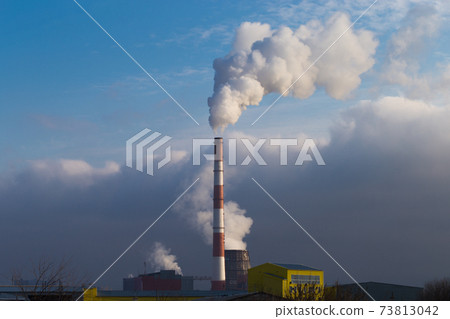 Heat and power plant emits harmful substances into the atmosphere. Pipe power plant against the background of the cloudy sky. 73813042