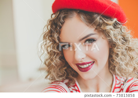 Happy young beautiful woman taking selfie on blurred background 73813858