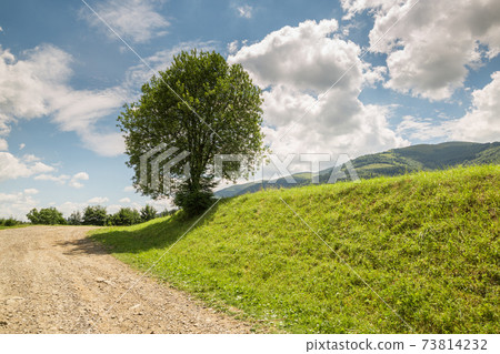 road with gravel stretches up the hill 73814232