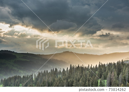 Storm clouds over mountains and the forest Storm clouds over mountains and the forest 73814262