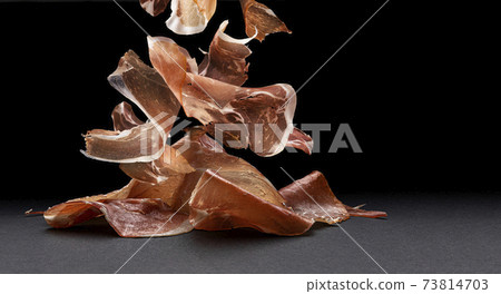 Falling jamon slices, raw pork ham isolated on black background 73814703