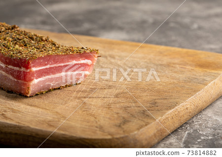 Appetizer cured pork belly in spices of herbs. 73814882