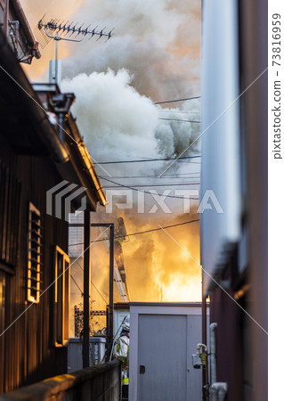 Firefighters wrapped in smoke during firefighting Firefighters wrapped in smoke during firefighting 73816959