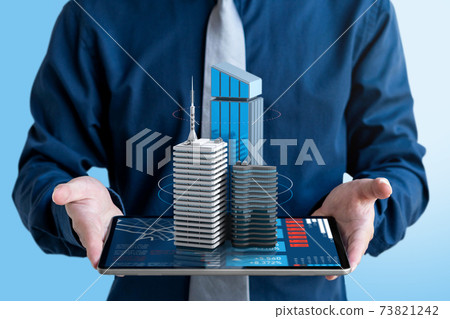 Businessman show 3d real estate building for investment on tablet screen. 73821242