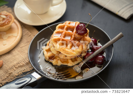 Coffee drink breakfast concept. Includes crispy tarts with almond, Waffles and fresh cherry Coffee drink breakfast concept. Includes crispy tarts with almond, Waffles and fresh cherry 73821647