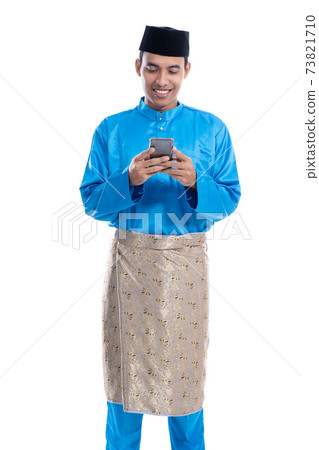 asian muslim man with mobile phone wearing koko melayu asian muslim man with mobile phone wearing koko melayu 73821710