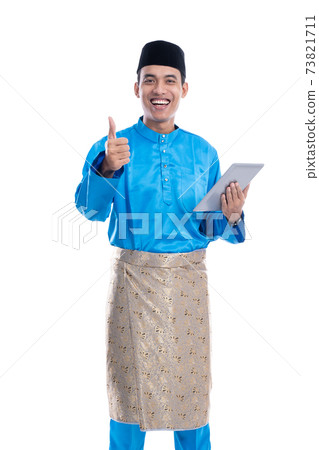 muslim melayu male with baju koko holding tablet muslim melayu male with baju koko holding tablet 73821711