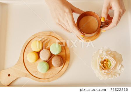 Table with coffee, dessert and flower. 73822216