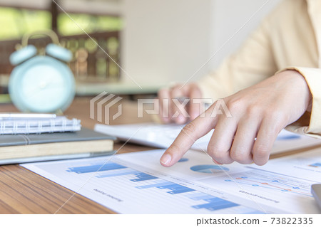 Financial businesswoman calculating corporate income tax data And analyzing charts of financial stocks that are in good condition with growth and progress Financial businesswoman calculating corporate income tax data And analyzing charts of financial stocks that are in good condition with growth and progress 73822335