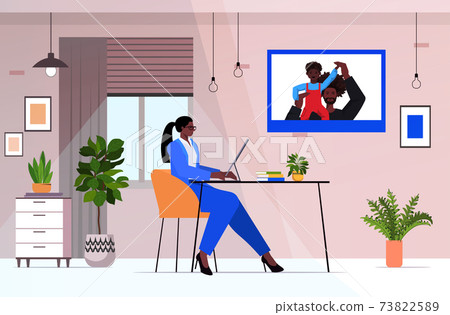 african american businesswoman discussing with husband and son during video call parenting concept african american businesswoman discussing with husband and son during video call parenting concept 73822589