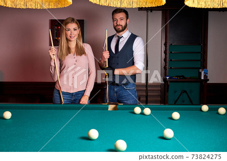 beautiful couple spend pleasant pastime playing billiards together, family rest, entertainment, holiday beautiful couple spend pleasant pastime playing billiards together, family rest, entertainment, holiday 73824275