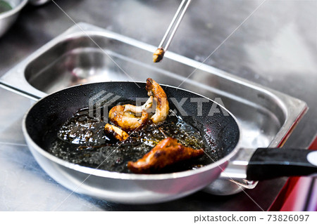 Chef cooking, Chef preparing food in the kitchen, Chef decorating dish, closeup. Chef cooking, Chef preparing food in the kitchen, Chef decorating dish, closeup. 73826097