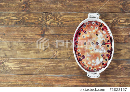 Clafoutis cherry pie - traditional french dessert in a white baking dish 73828167