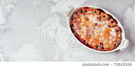 Clafoutis cherry pie - traditional french dessert in a white baking dish 73828168
