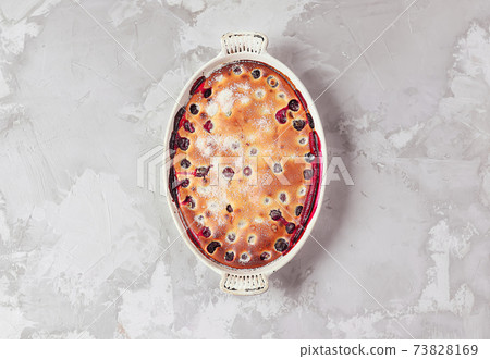 Clafoutis cherry pie - traditional french dessert in a white baking dish 73828169